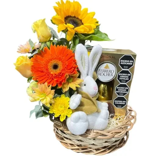 Canasta de pascua con flores huevo rocher y conejo